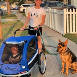 Mom with child in blue double Booyah Stroller with German Shepard Dog