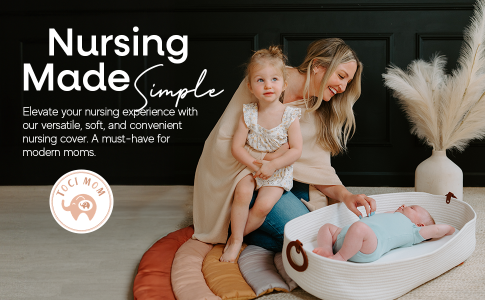 Mother with baby and child. Baby is in stylish white moses basket. 